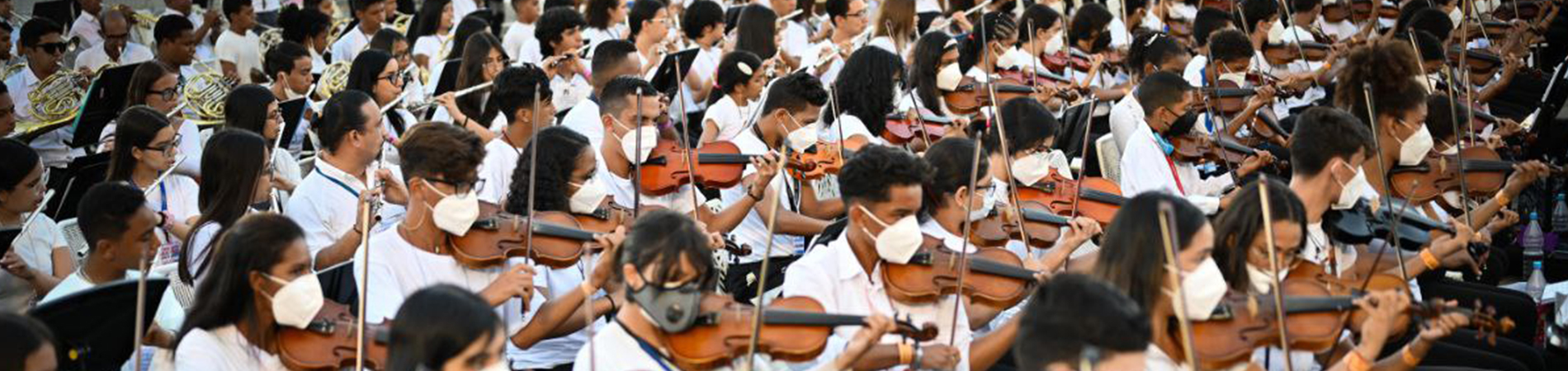 large group of people playing violin