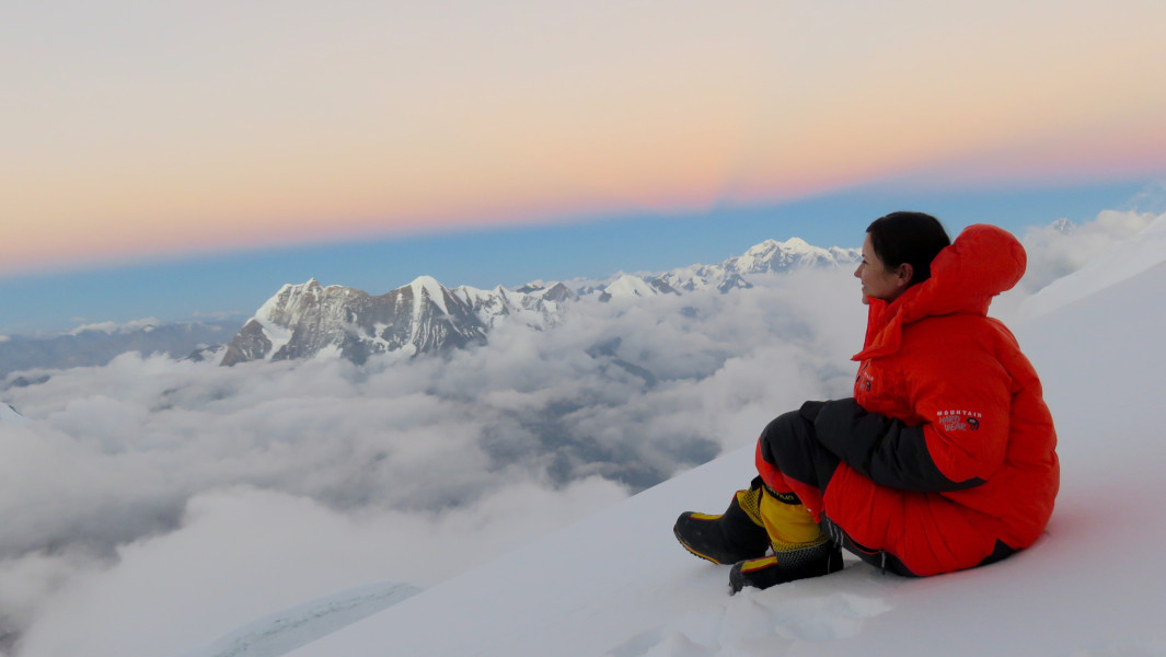 Viridiana looks out at the clouds from the summit
