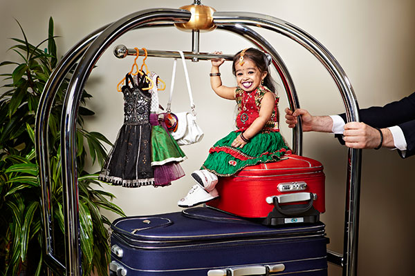 jyoti on top of red suitcase
